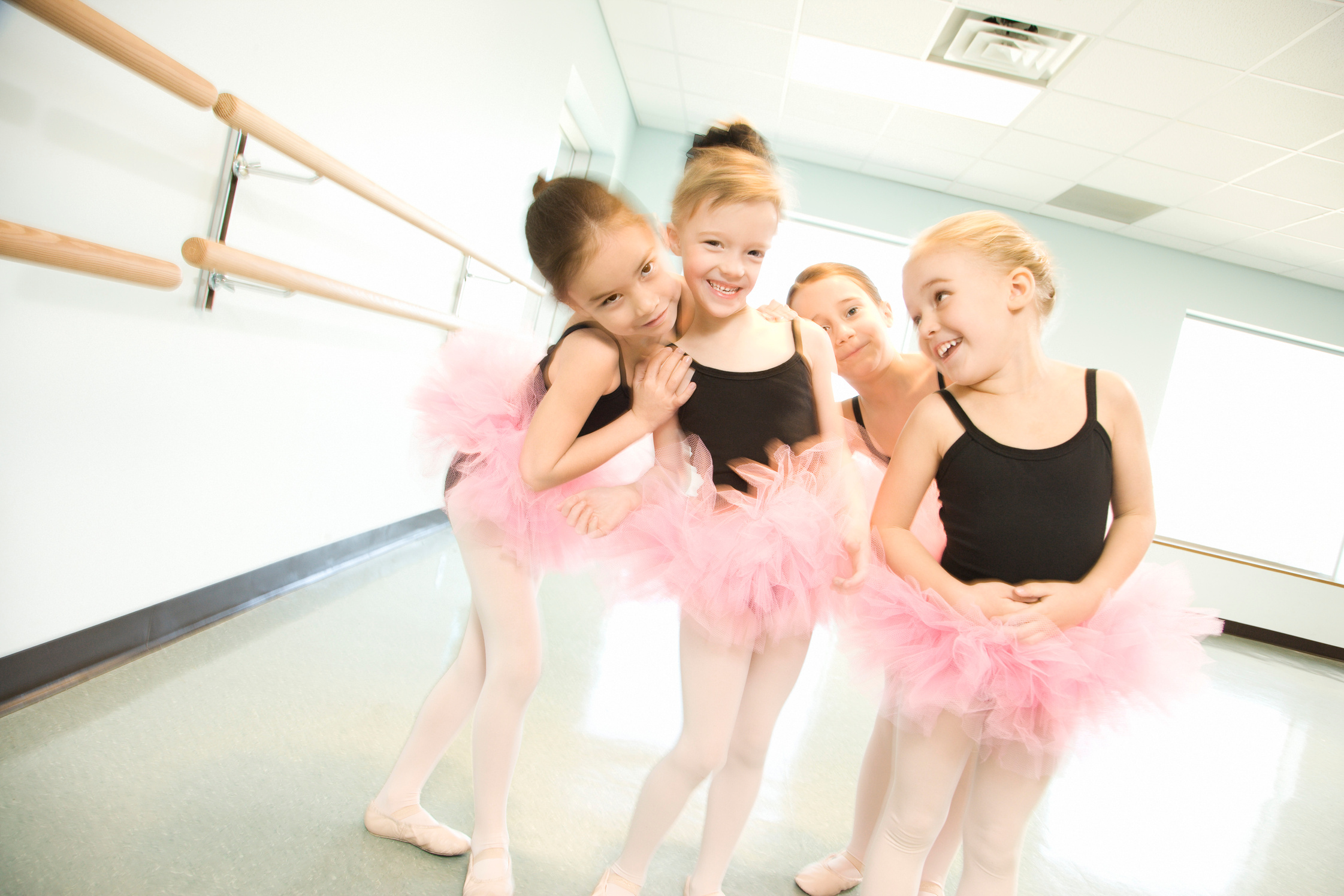 Girls in ballet class posing together
